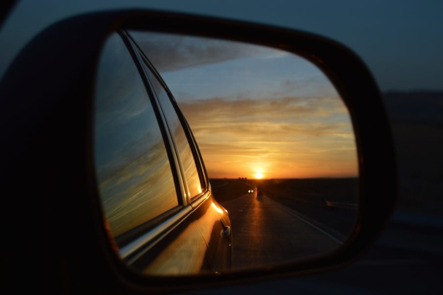 sunset through the side mirror of a car